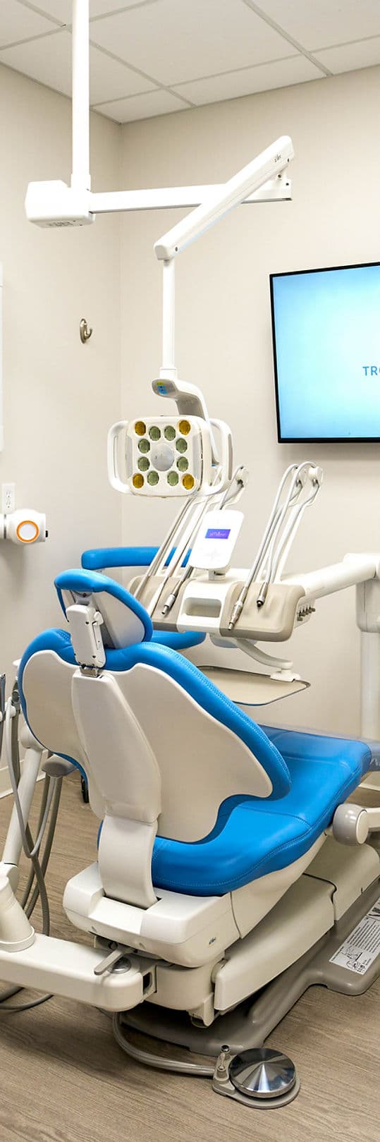 Blue dental chair in a bright treatment room at Troy Meadows Dental